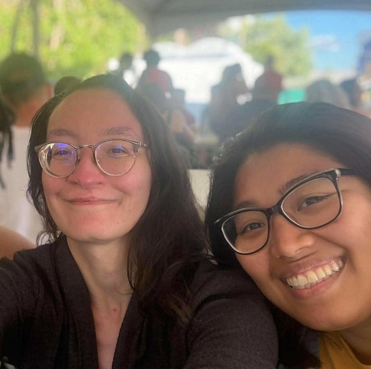 Muchtar and a friend smiling at an outdoor summer event