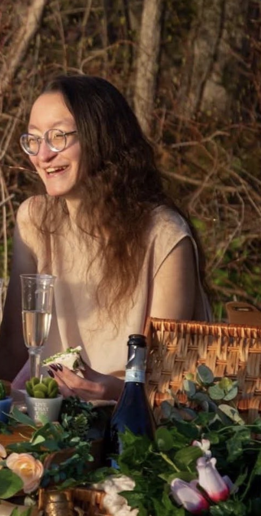 Muchtar laughing at a golden-hour picnic table