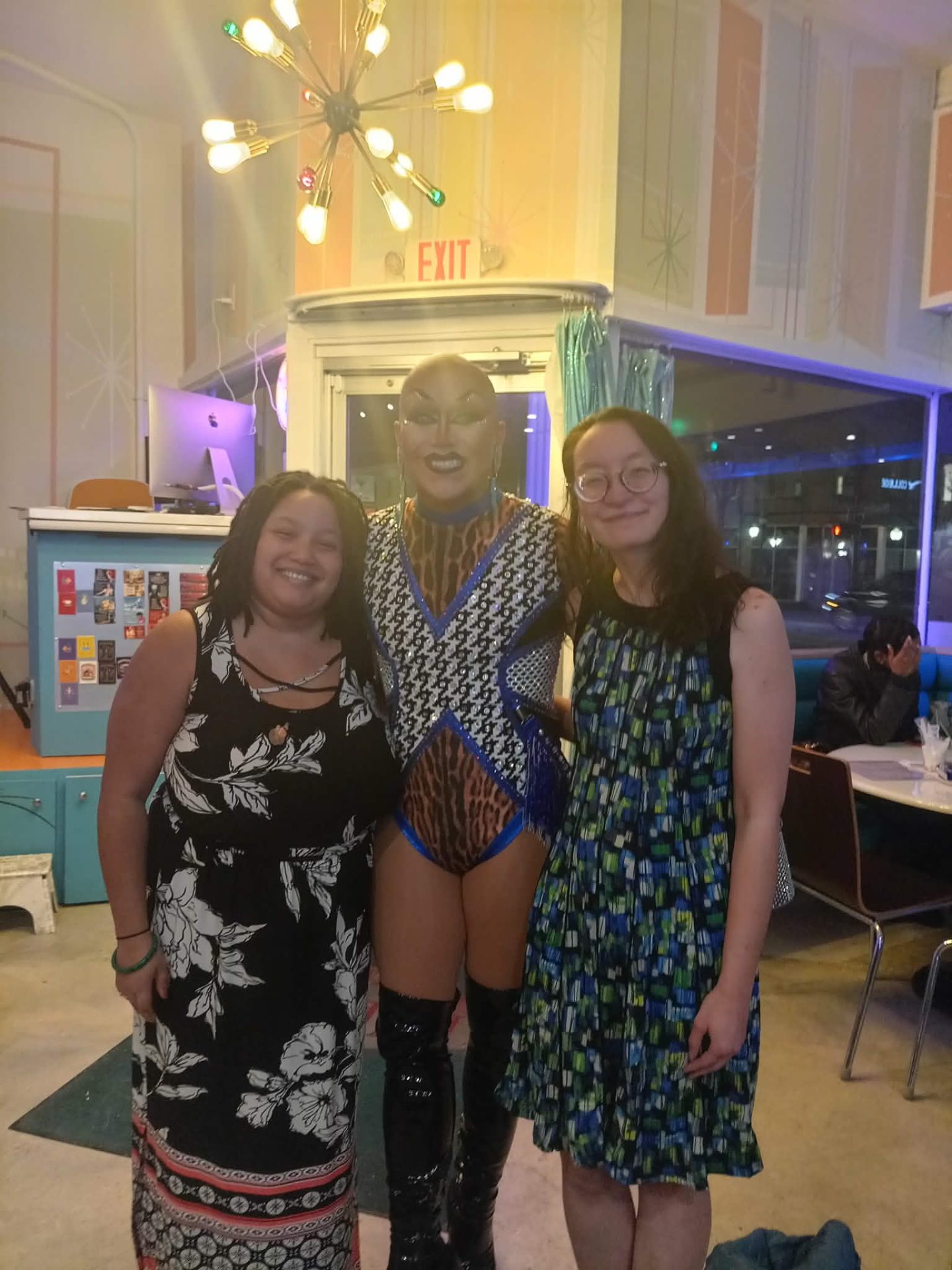 Muchtar and friends with a drag performer at a diner